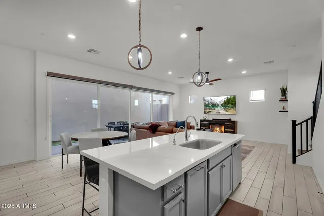 a large kitchen with a table and chairs