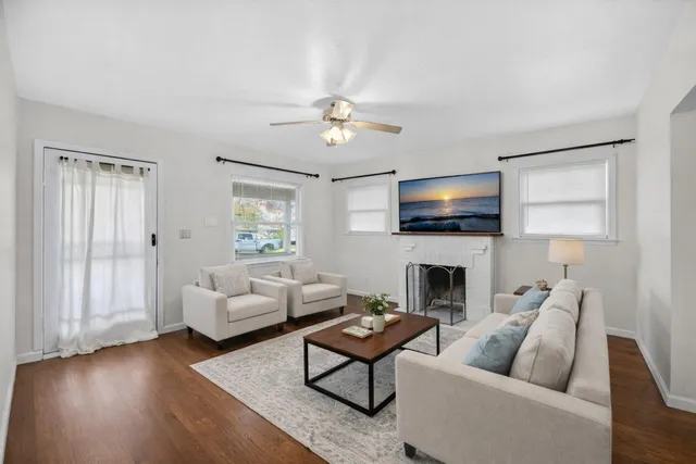 a living room with furniture a fireplace and a flat screen tv
