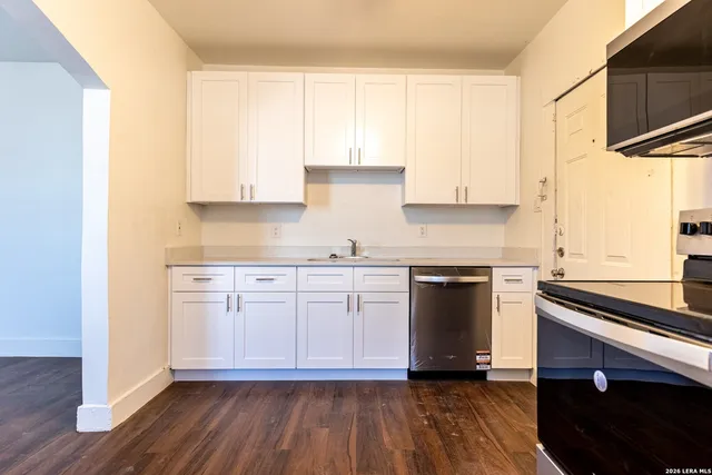 a kitchen with a sink window and cabinets