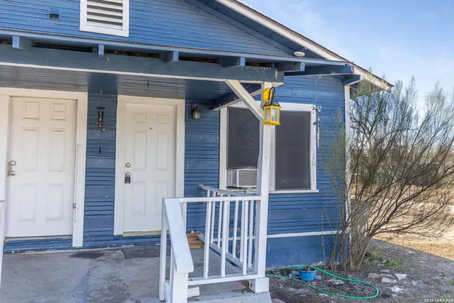 a view of a house with a wooden fence