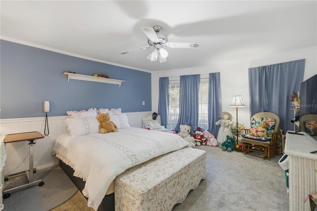 9151 Southwest 157th Lane Dunnellon, FL 34432 - Photo 17 of 63 a bedroom with bed couch and window