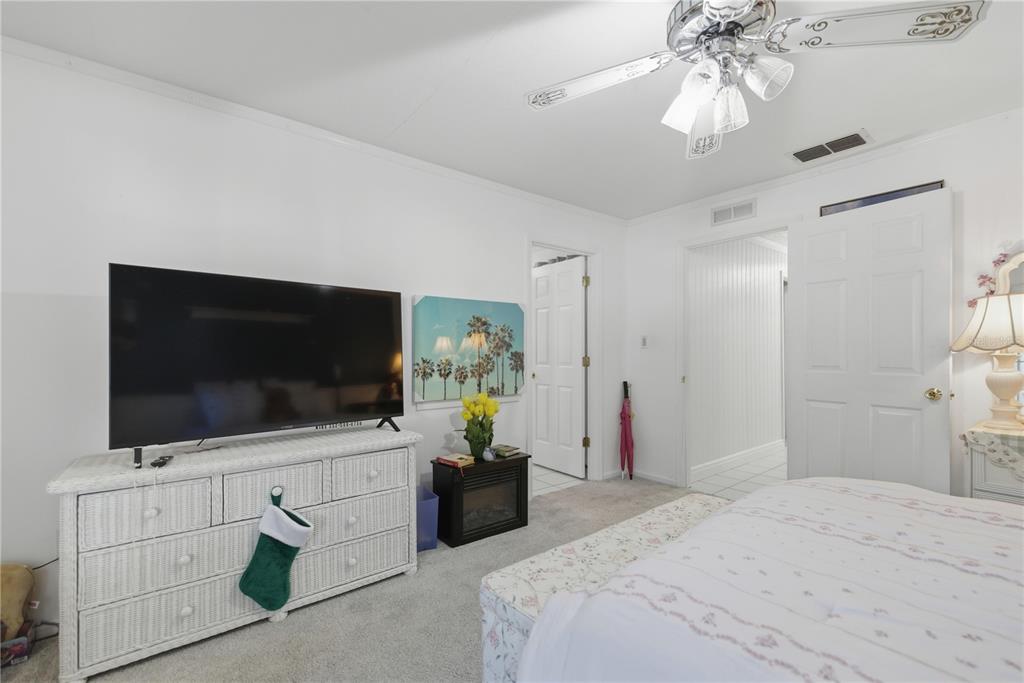 9151 Southwest 157th Lane Dunnellon, FL 34432 - Photo 18 of 63 a bedroom with a flat screen television and a bed