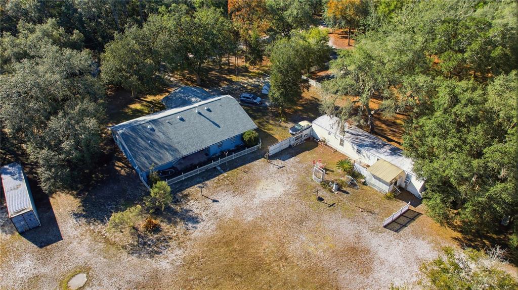9151 Southwest 157th Lane Dunnellon, FL 34432 - Photo 2 of 63 an aerial view of a house with yard and trees