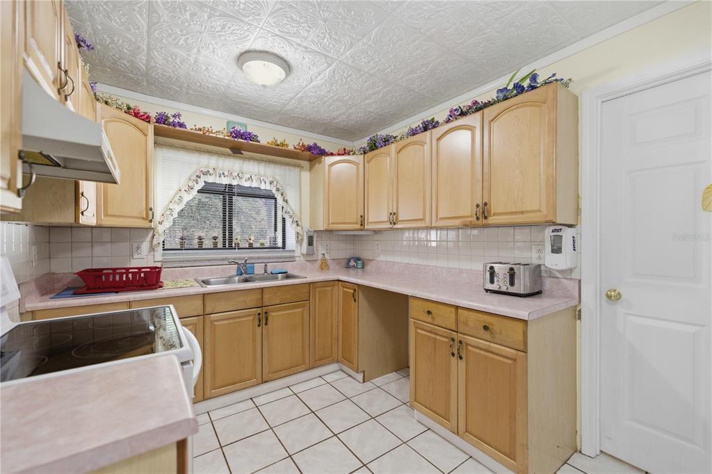 9151 Southwest 157th Lane Dunnellon, FL 34432 - Photo 21 of 63 a kitchen with a sink cabinets and window
