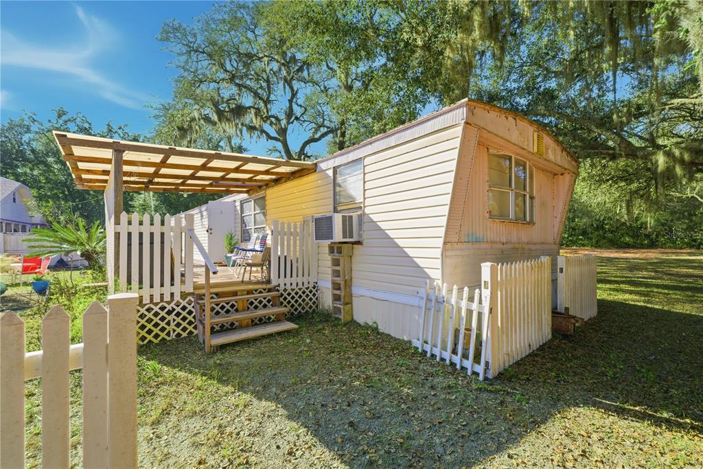 9151 Southwest 157th Lane Dunnellon, FL 34432 - Photo 36 of 63 a view of a house with a small yard and wooden fence