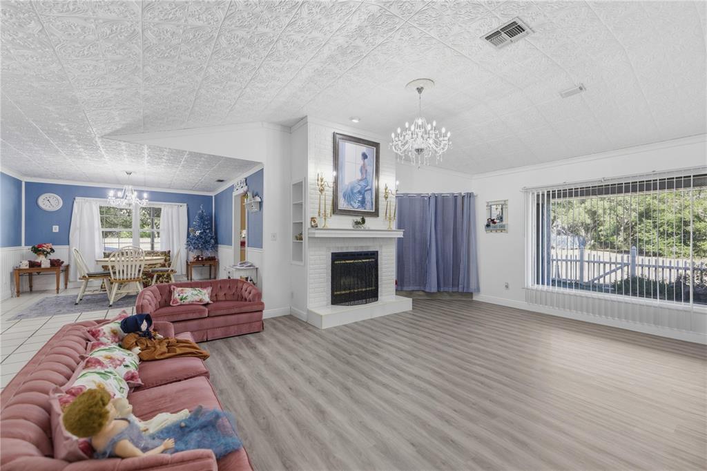 9151 Southwest 157th Lane Dunnellon, FL 34432 - Photo 4 of 63 a living room with furniture a fireplace and a large window