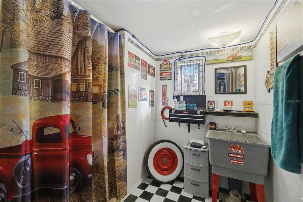 9151 Southwest 157th Lane Dunnellon, FL 34432 - Photo 41 of 63 a utility room with fridge and wooden floor