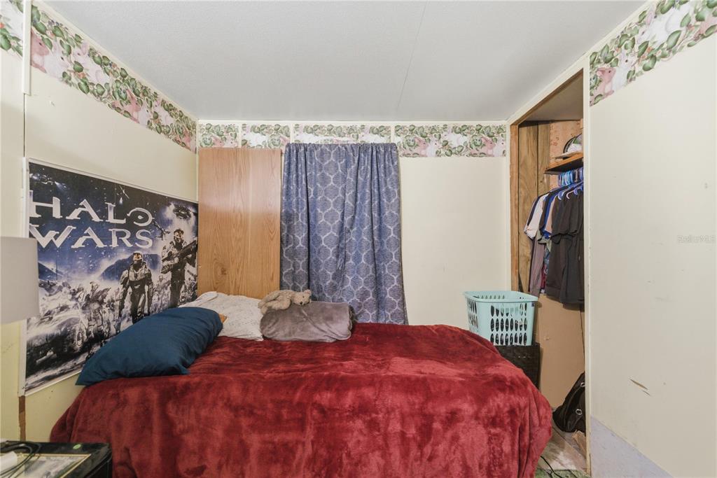 9151 Southwest 157th Lane Dunnellon, FL 34432 - Photo 43 of 63 a bedroom with a bed and a window