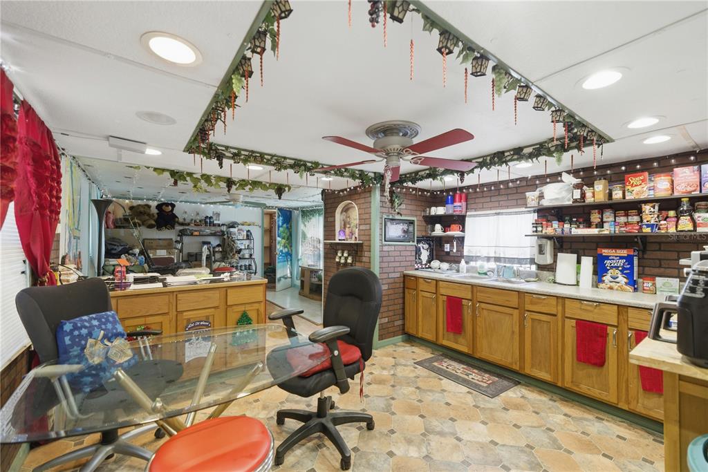 9151 Southwest 157th Lane Dunnellon, FL 34432 - Photo 44 of 63 a kitchen with stainless steel appliances kitchen island granite countertop lots of furniture and white cabinets