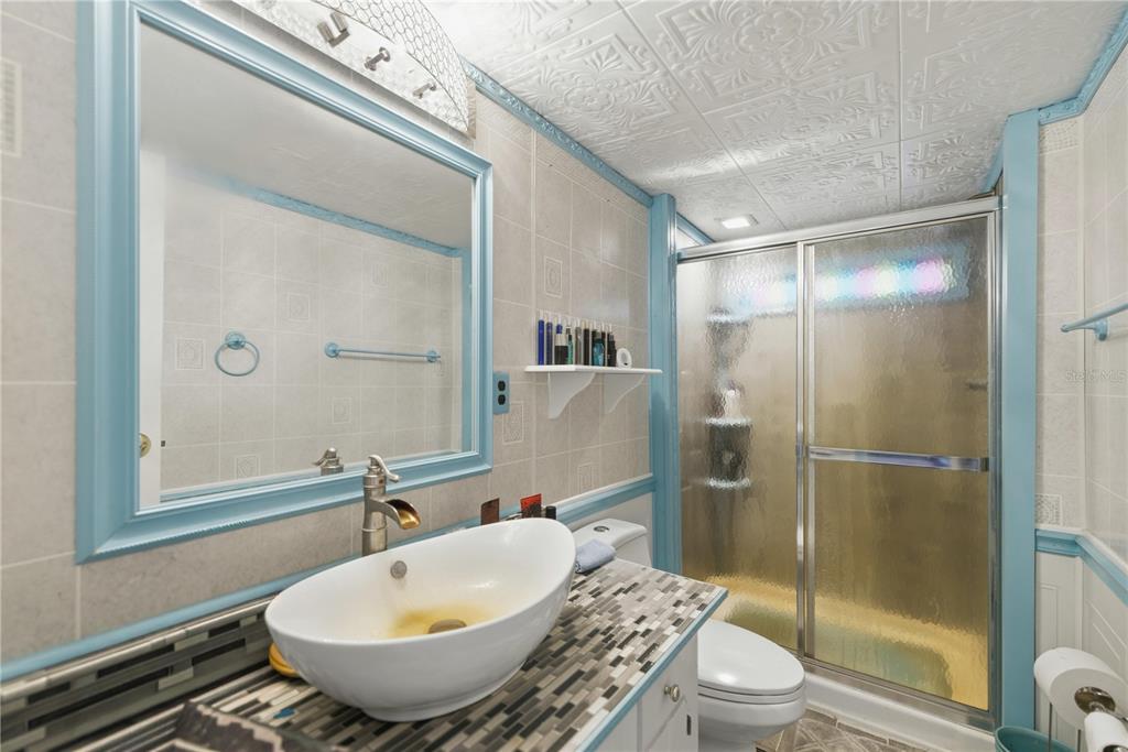 9151 Southwest 157th Lane Dunnellon, FL 34432 - Photo 49 of 63 a bathroom with a granite countertop sink toilet and shower