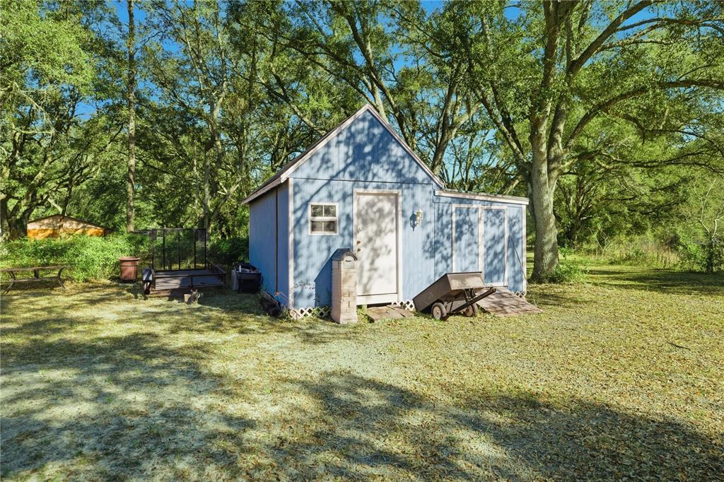 9151 Southwest 157th Lane Dunnellon, FL 34432 - Photo 52 of 63 a view of a house with backyard porch and sitting area