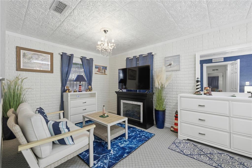 9151 Southwest 157th Lane Dunnellon, FL 34432 - Photo 7 of 63 a living room with furniture a flat screen tv and a dining table