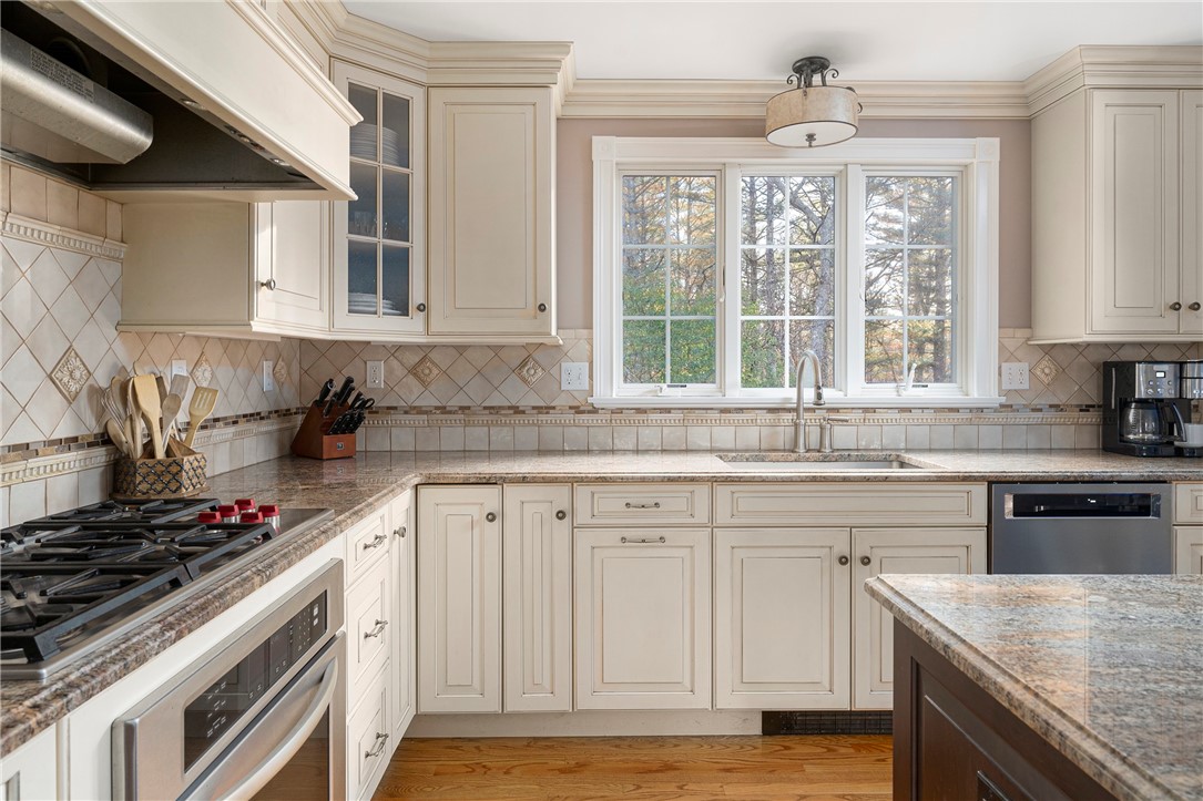119 Locust Valley Road Exeter, RI 02822 - Photo 14 of 50 New Wolf 5 Burner Gas Cooktop, Double Ovens. Brookhaven Cabinetry, Custom Tile Backsplash, Granite Surfaces.