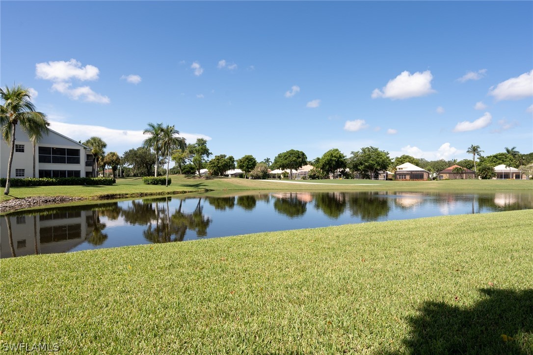 14979 Rivers Edge Court, Unit 223 Fort Myers, FL 33908 - Photo 1 of 21 a view of a lake with houses in the background