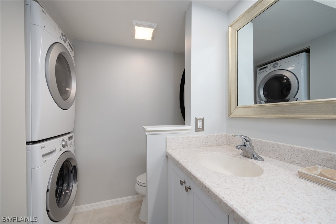 14979 Rivers Edge Court, Unit 223 Fort Myers, FL 33908 - Photo 12 of 21 a utility room with sink dryer and washer