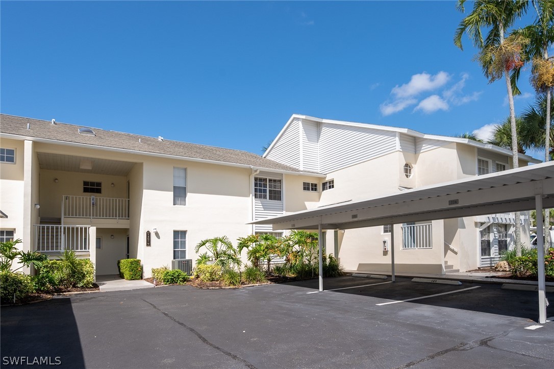 14979 Rivers Edge Court, Unit 223 Fort Myers, FL 33908 - Photo 13 of 21 a front view of a house with a yard