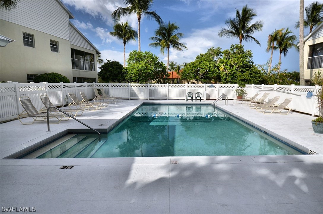 14979 Rivers Edge Court, Unit 223 Fort Myers, FL 33908 - Photo 14 of 21 a swimming pool with outdoor seating and yard