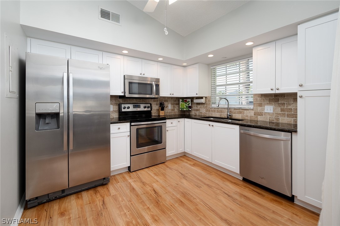 14979 Rivers Edge Court, Unit 223 Fort Myers, FL 33908 - Photo 2 of 21 a kitchen with a refrigerator sink and microwave
