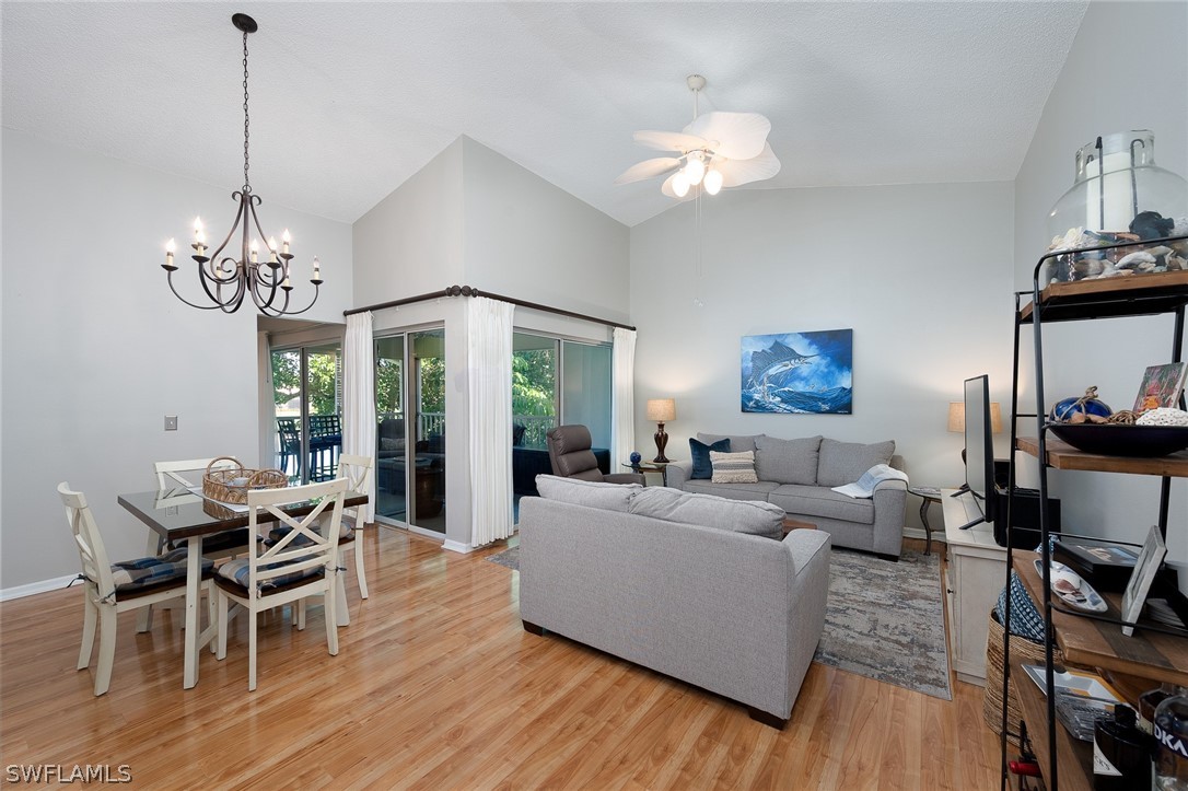 14979 Rivers Edge Court, Unit 223 Fort Myers, FL 33908 - Photo 3 of 21 a living room with furniture and a chandelier
