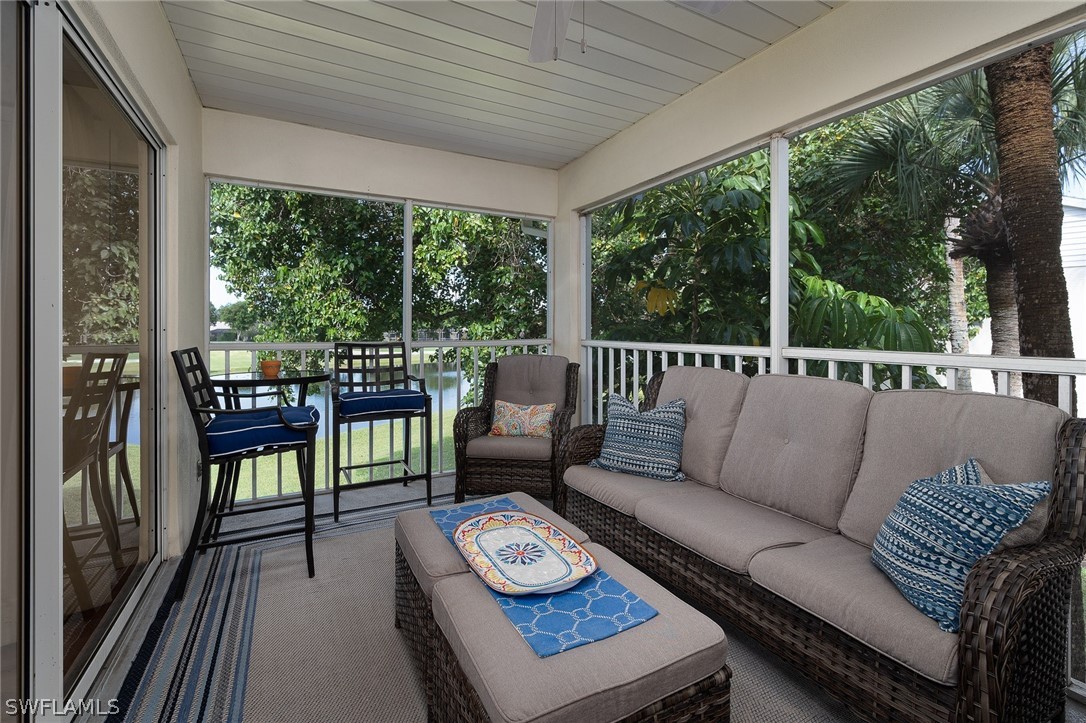 14979 Rivers Edge Court, Unit 223 Fort Myers, FL 33908 - Photo 4 of 21 a living room with furniture and a floor to ceiling window