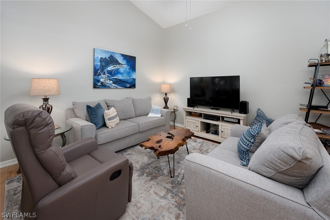 14979 Rivers Edge Court, Unit 223 Fort Myers, FL 33908 - Photo 6 of 21 a living room with furniture and a flat screen tv