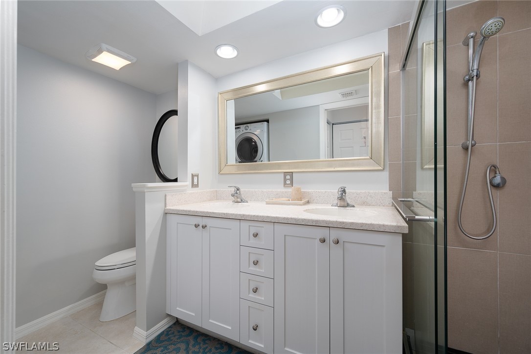 14979 Rivers Edge Court, Unit 223 Fort Myers, FL 33908 - Photo 9 of 21 a bathroom with a granite countertop sink toilet and shower