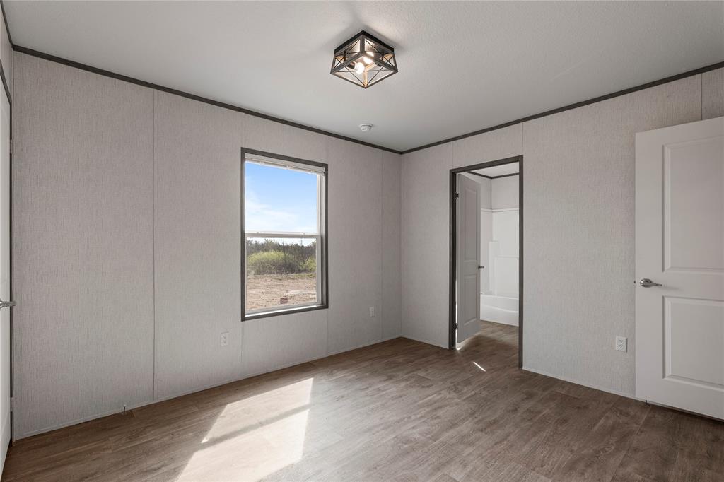 3888 Sandusky Road Whitesboro, TX 76273 - Photo 20 of 24 Unfurnished bedroom with ornamental molding and wood finished floors