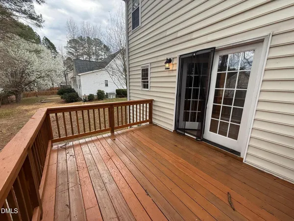 a view of balcony with wooden floor and fence