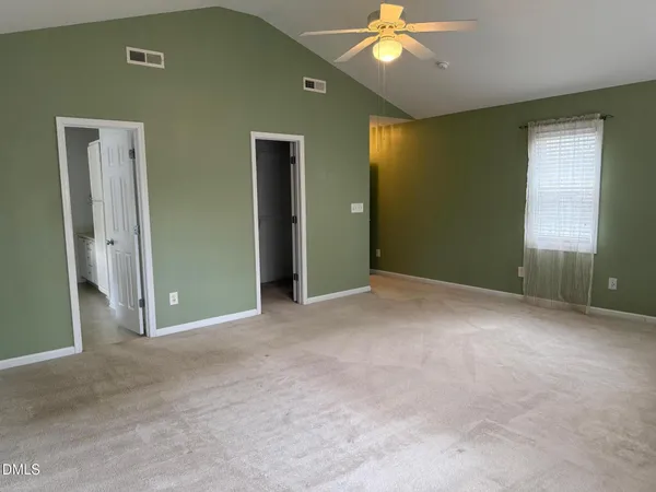 a view of a livingroom with a ceiling fan and window