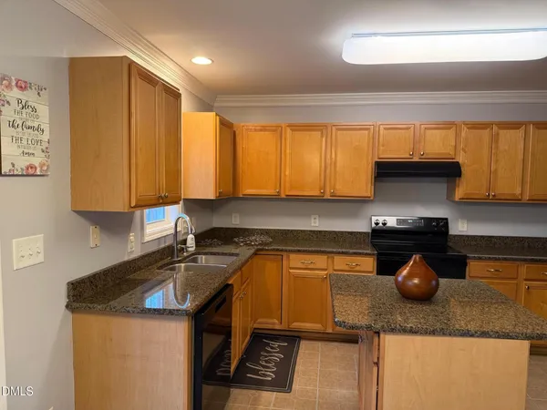 a kitchen with stainless steel appliances granite countertop a sink a stove and a microwave
