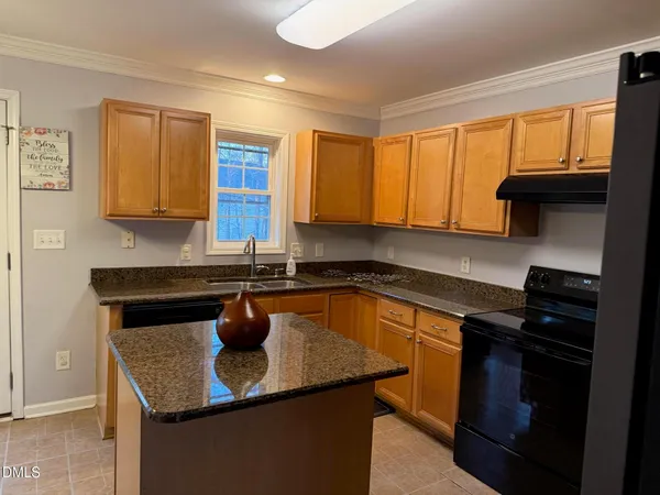 a kitchen with a sink a stove and a window