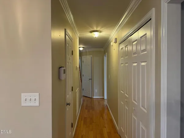 a view of a hallway with wooden floor