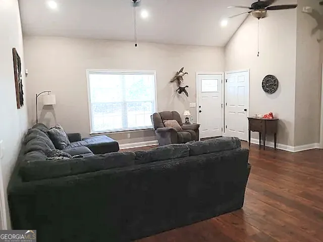 an empty room with wooden floor and cabinet