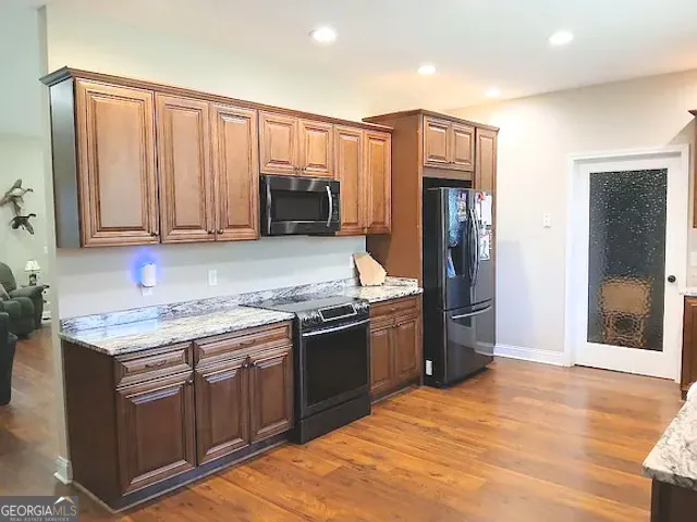 a bathroom with a granite countertop sink and a bathtub