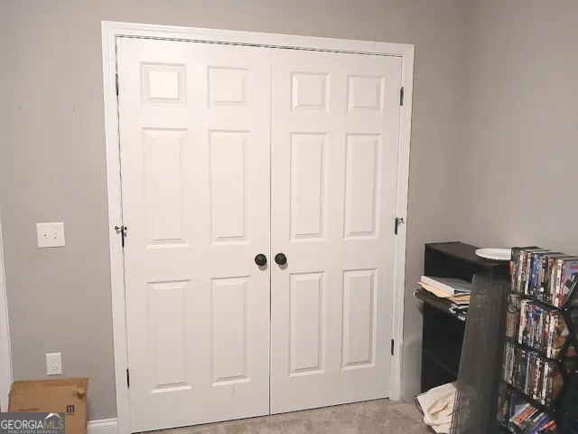 a bedroom with a bed and a ceiling fan