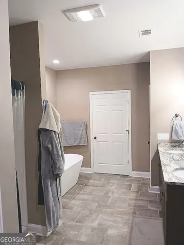 a white toilet sitting next to a sink