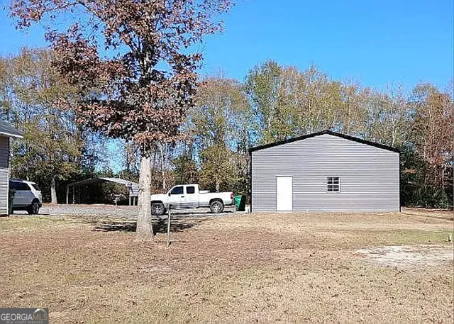a front view of a house with a yard and seating space