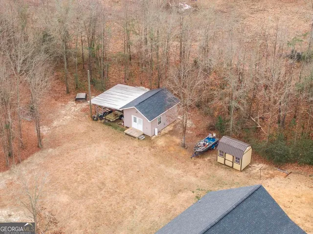 an aerial view of a house with yard