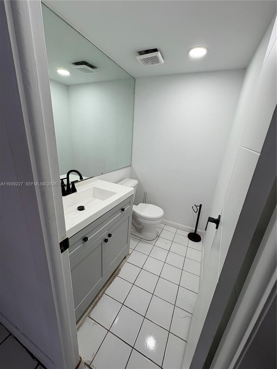 1331 Lincoln Road, Unit 402 Miami Beach, FL 33139 - Photo 13 of 20 a bathroom with a sink a toilet a mirror and shower