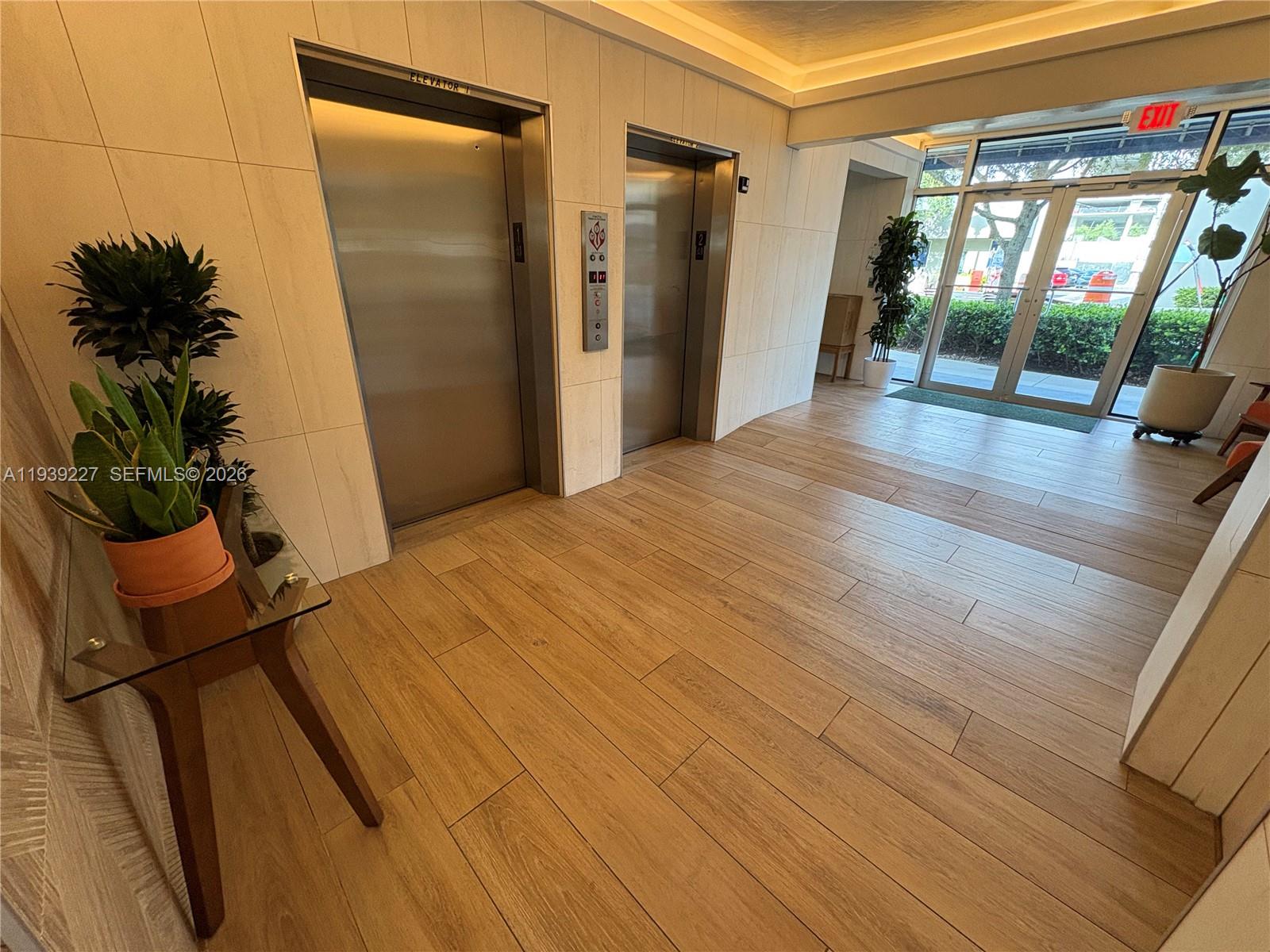 1331 Lincoln Road, Unit 402 Miami Beach, FL 33139 - Photo 3 of 20 a view of a room with wooden floor and potted plant