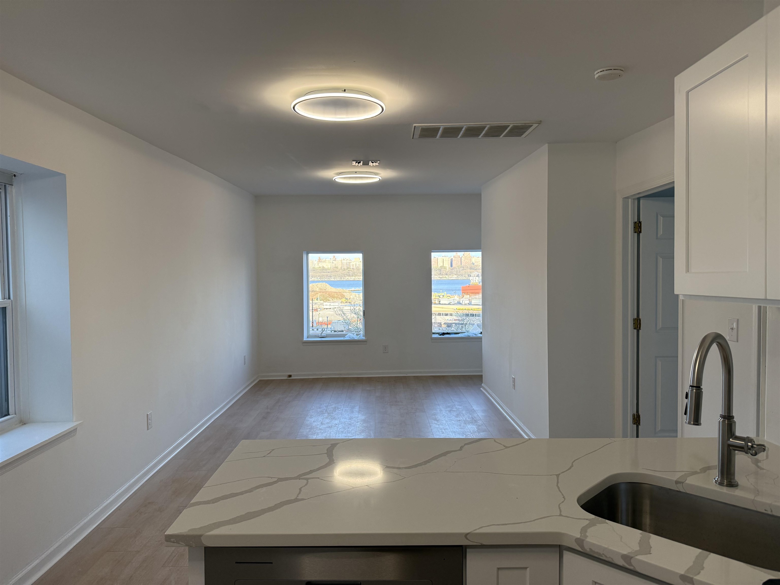 a view of a kitchen with a sink cabinets and a window