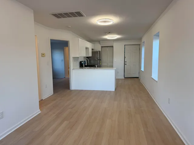 a view of a kitchen with wooden floor