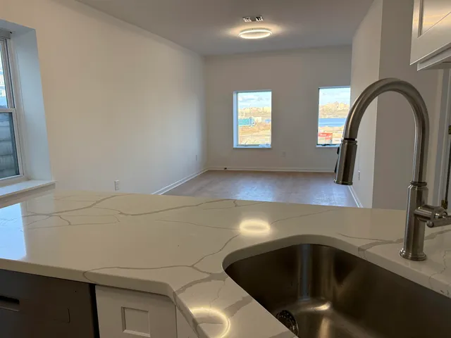 a kitchen with a sink and a mirror