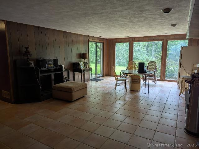 35 Sturbridge Road Easton, CT 06612 - Photo 19 of 23 a living room with furniture a flat screen tv and floor to ceiling window