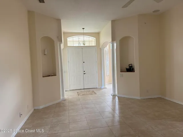 a view of a bathroom with sink mirror and window