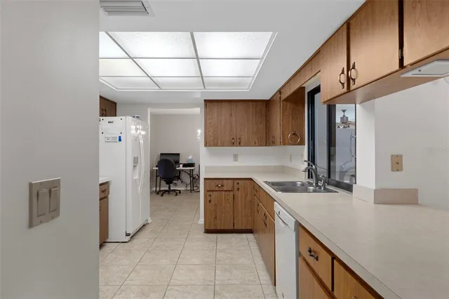 a kitchen with a sink appliances and cabinets