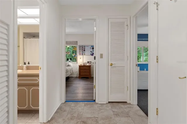 a view of a hallway with bathroom and a bathroom