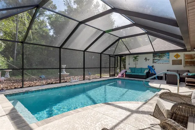 a view of a patio with table and chairs under an umbrella