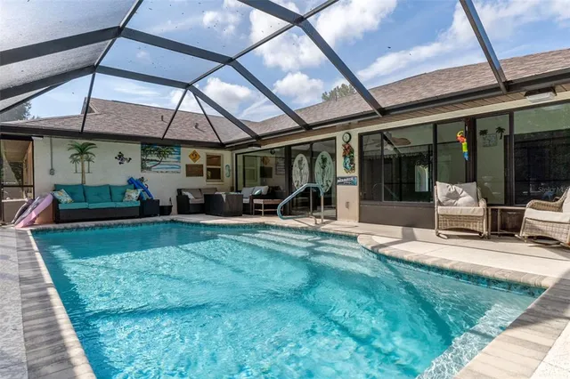 a view of swimming pool with a sitting area