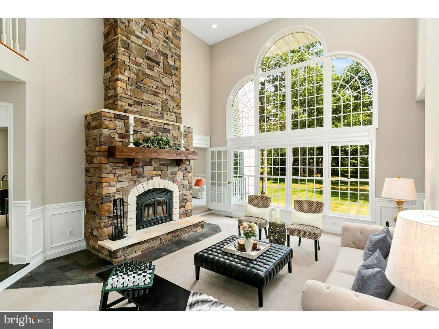 Living Room with 2 story stone fireplace & window